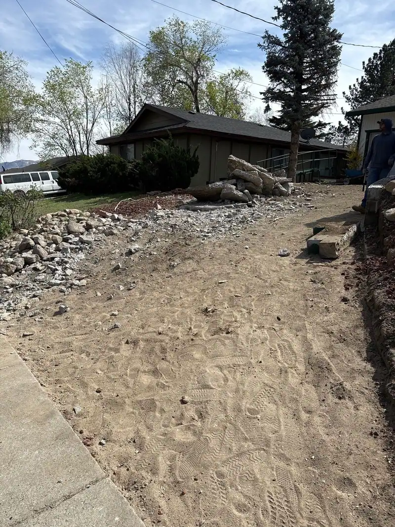 A side path cleared down to bare dirt beside a house