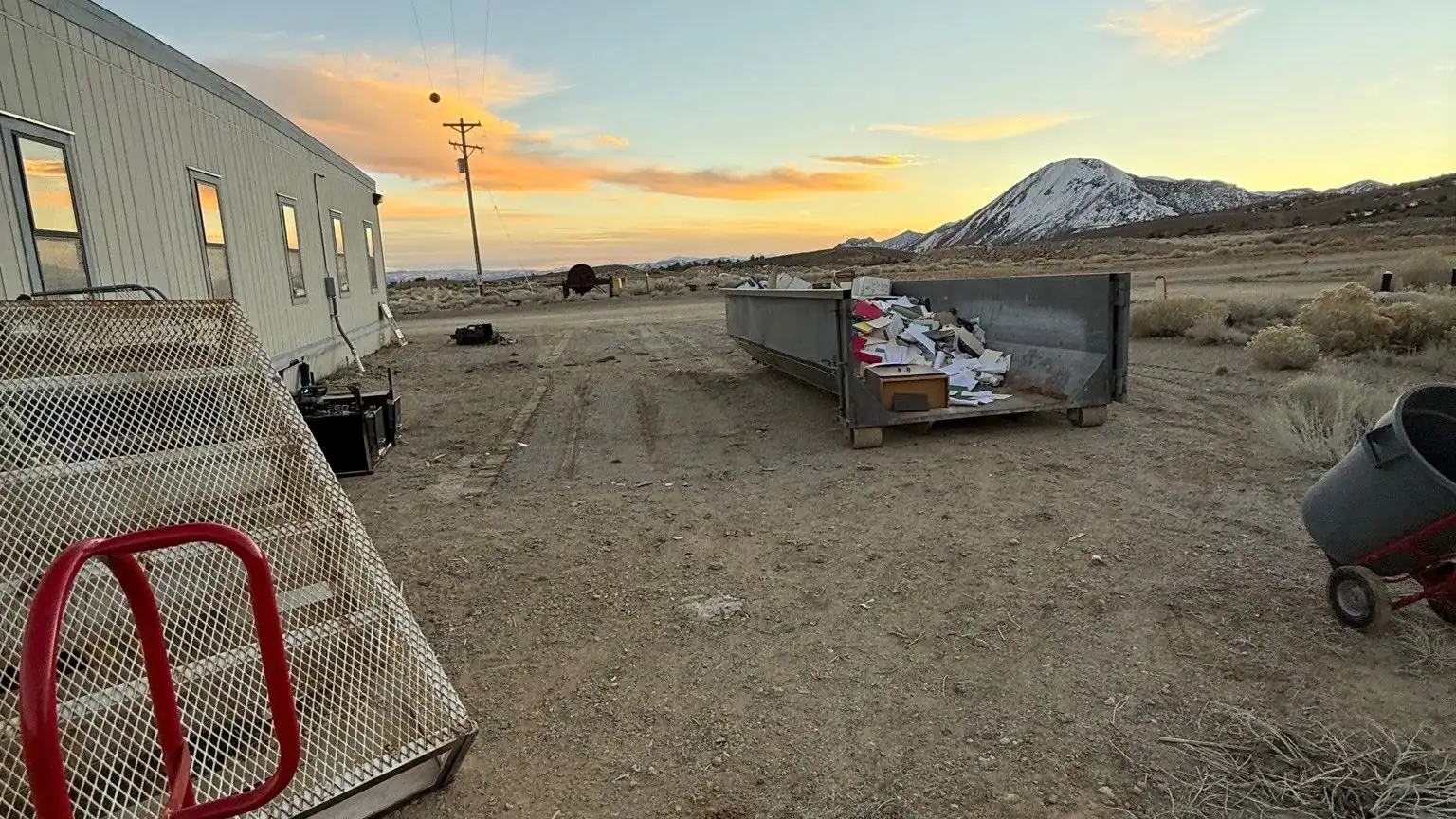 A roll-off dumpster dropped on an open lot