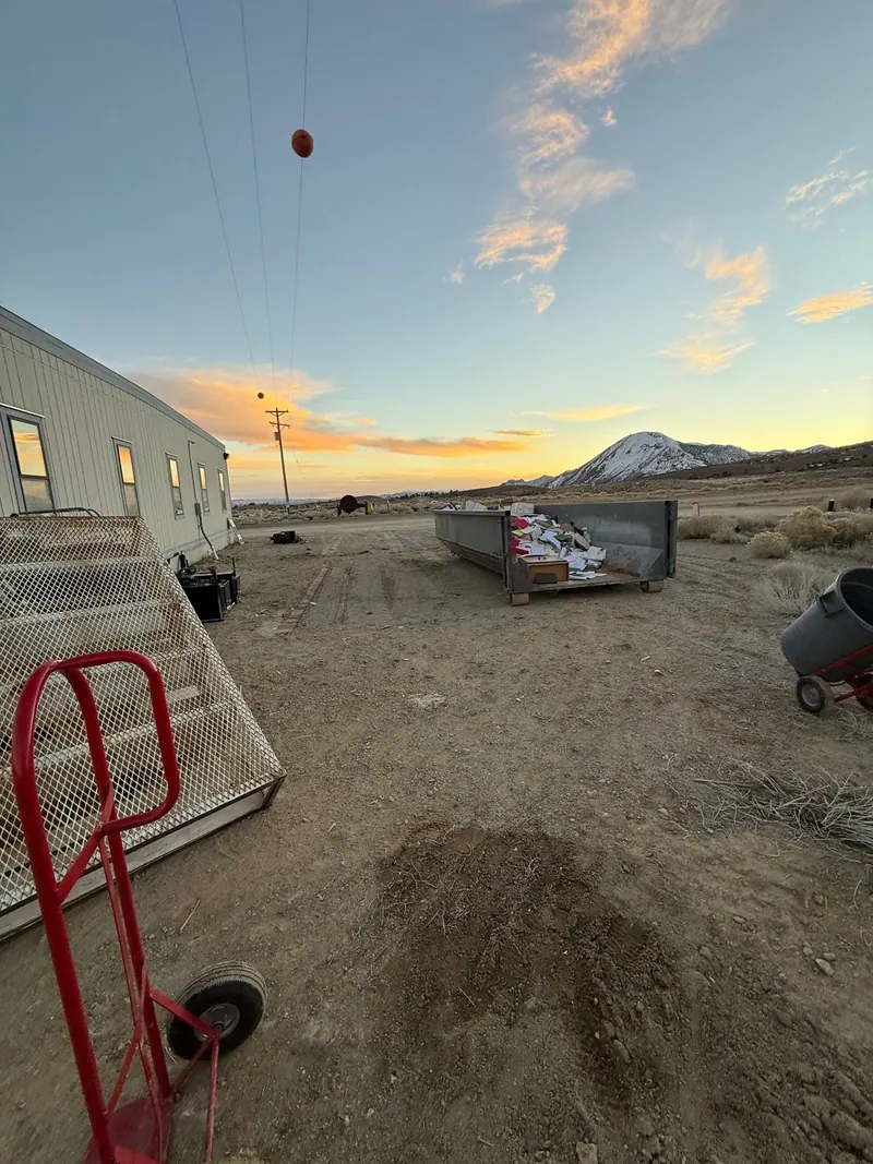 A roll-off dumpster dropped on an open lot