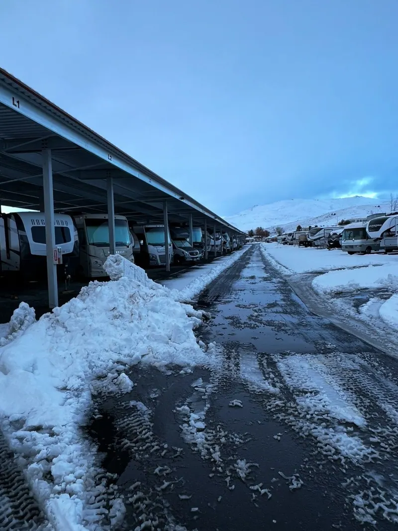 A carport lot with the snow pushed into piles