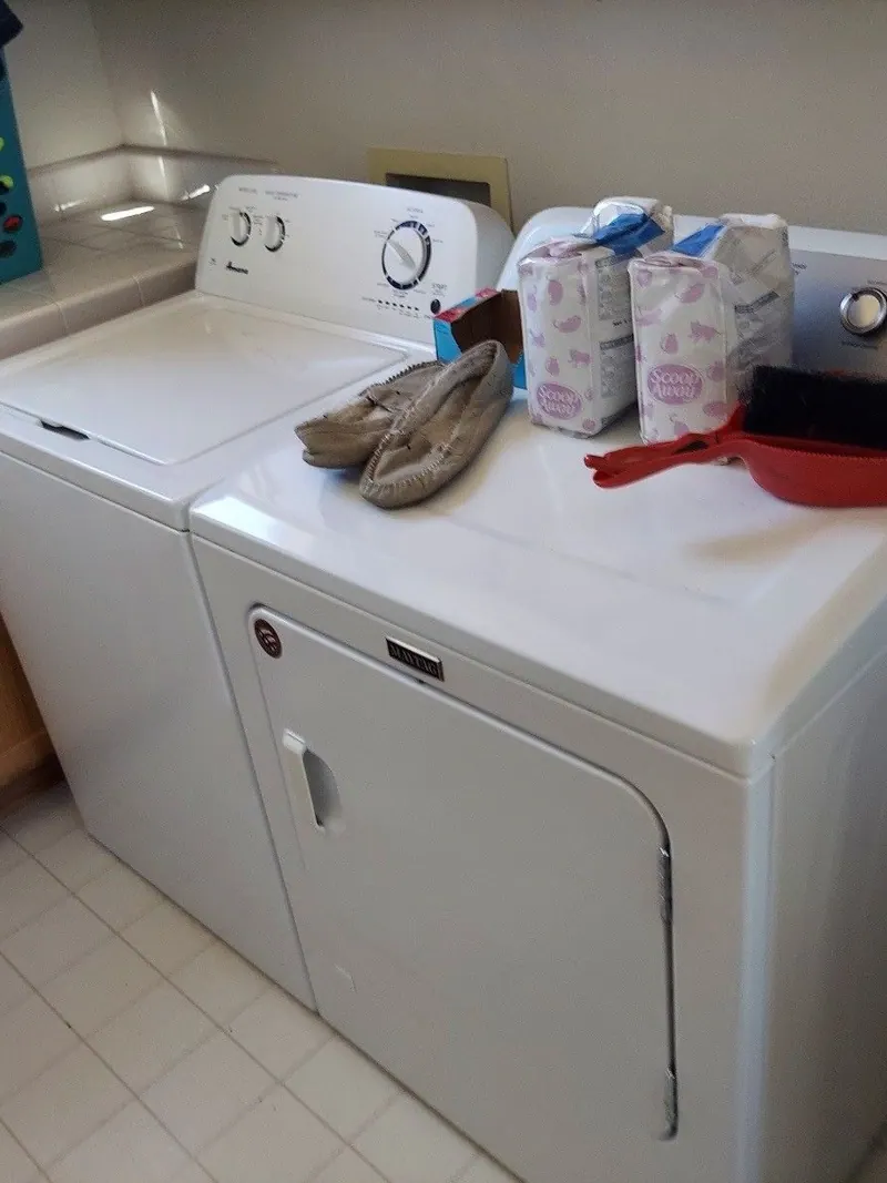 A white washer and dryer in a laundry room