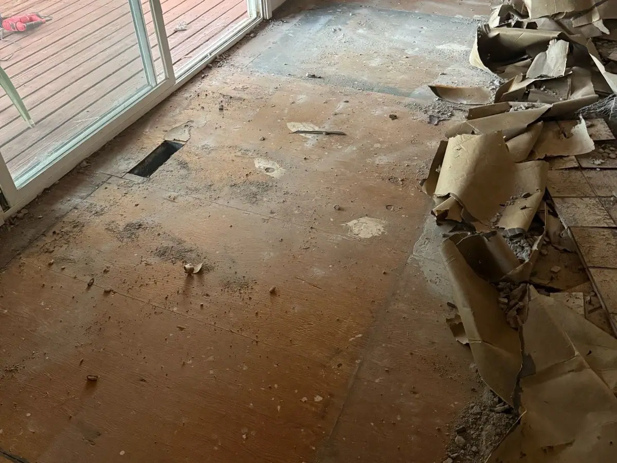 The same room with the tile off down to the subfloor