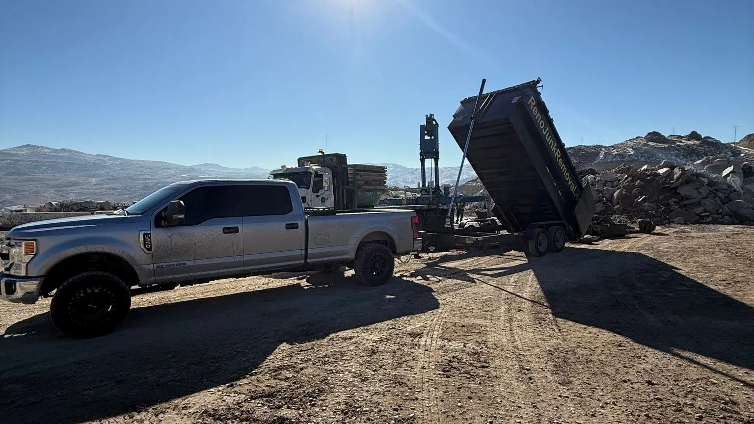 The dump trailer tipping a load at the dump site