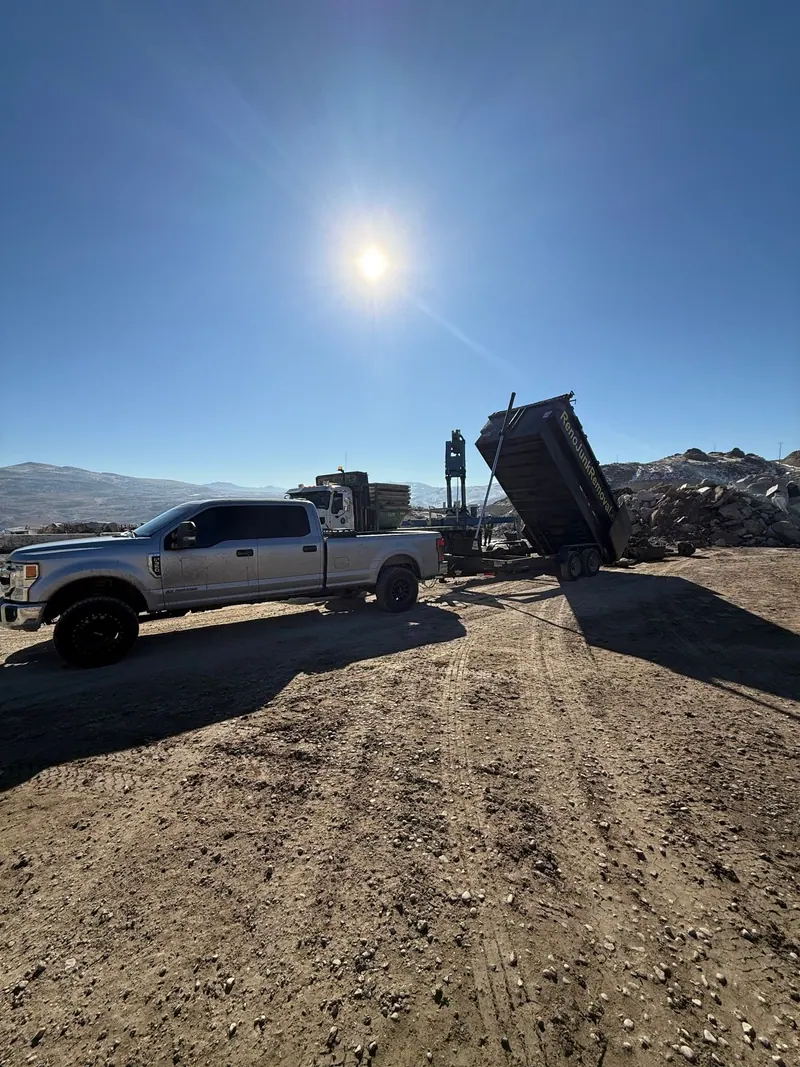 The dump trailer tipping a load at the dump site