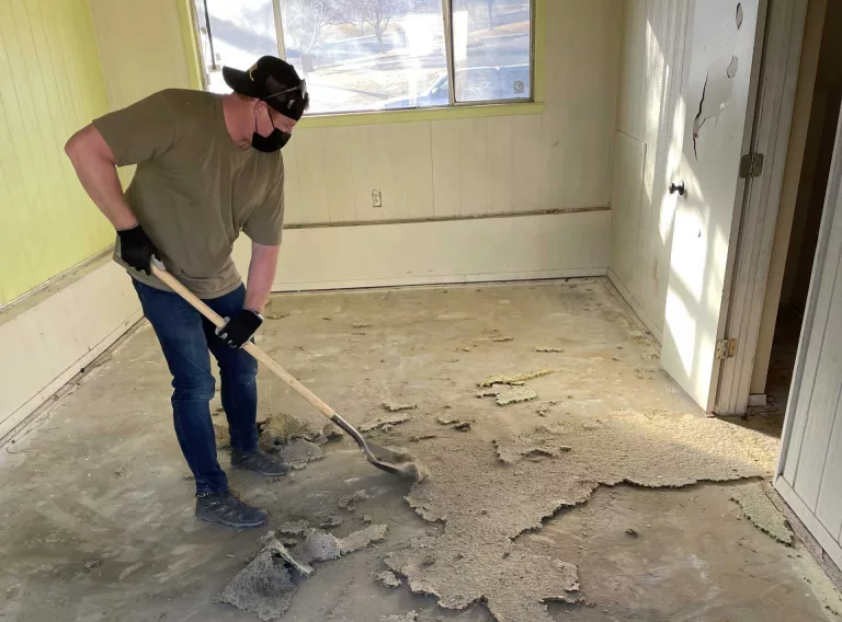 Worker removing flooring